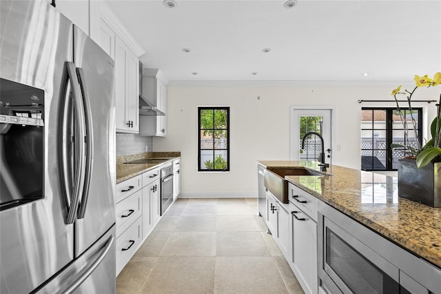 1047 Banks Rose St, Kissimmee, FL 34747 - kitchen featuring stainless steel appliances, a sink, tasteful backsplash, light stone countertops, and crown molding