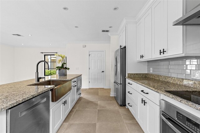 1047 Banks Rose St, Kissimmee, FL 34747 - kitchen with stainless steel appliances, exhaust hood, a sink, white cabinets, and recessed lighting