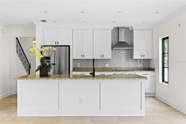 1047 Banks Rose St, Kissimmee, FL 34747 - kitchen featuring wall chimney range hood, stainless steel fridge with ice dispenser, a sink, an island with sink, and decorative backsplash