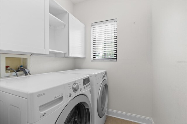 1047 Banks Rose St, Kissimmee, FL 34747 - laundry area featuring washing machine and dryer, cabinet space, and baseboards