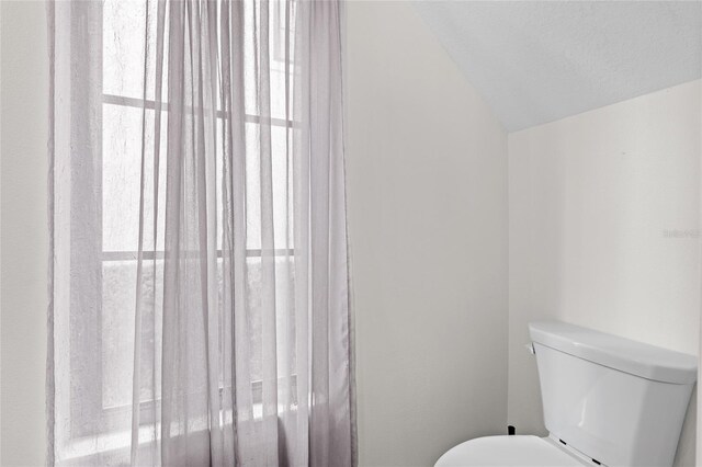 1047 Banks Rose St, Kissimmee, FL 34747 - bathroom with vaulted ceiling and toilet
