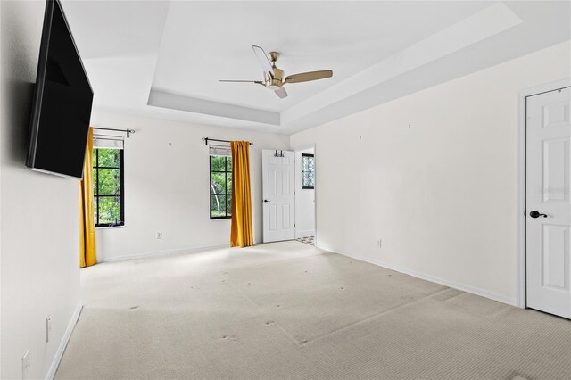 1047 Banks Rose St, Kissimmee, FL 34747 - carpeted spare room with a tray ceiling, baseboards, and ceiling fan