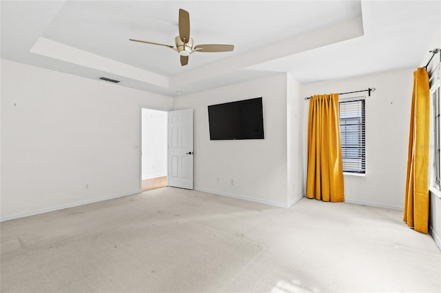 1047 Banks Rose St, Kissimmee, FL 34747 - spare room featuring a raised ceiling, light carpet, baseboards, and a ceiling fan