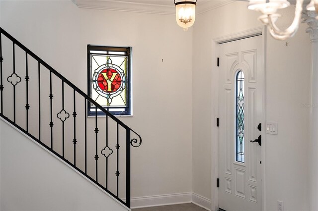 1047 Banks Rose St, Kissimmee, FL 34747 - foyer with a chandelier, crown molding, stairs, and baseboards