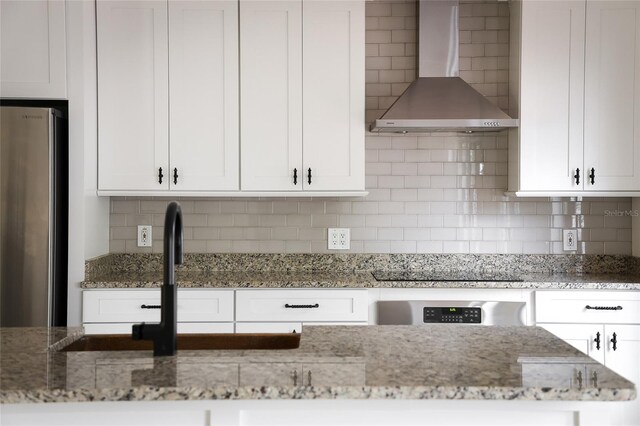 1047 Banks Rose St, Kissimmee, FL 34747 - kitchen featuring freestanding refrigerator, wall chimney range hood, black electric cooktop, and white cabinets