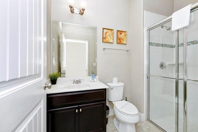 4416 Acorn Ct, Davenport, FL 33837 - bathroom featuring a stall shower, toilet, vanity, and tile patterned floors