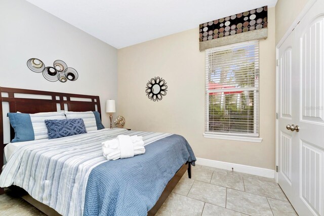 4416 Acorn Ct, Davenport, FL 33837 - bedroom with baseboards and light tile patterned flooring