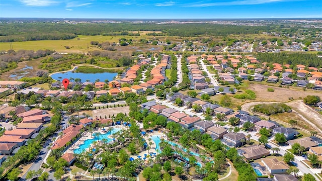 4416 Acorn Ct, Davenport, FL 33837 - aerial view of property's location featuring nearby suburban area, a large body of water, and a pool area