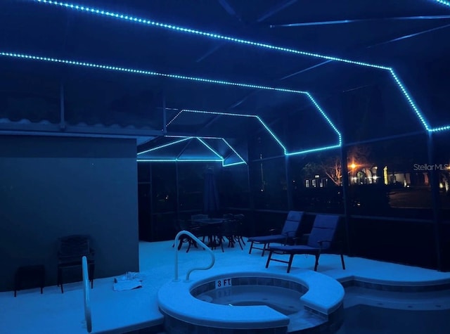 4416 Acorn Ct, Davenport, FL 33837 - patio at twilight featuring glass enclosure and a pool with connected hot tub