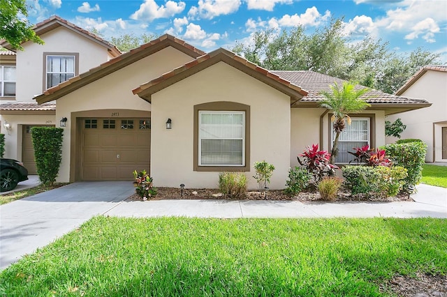 2473 Saint Augustine Blvd, Haines City, FL 33844 - mediterranean / spanish house with a tile roof, concrete driveway, stucco siding, and a front lawn