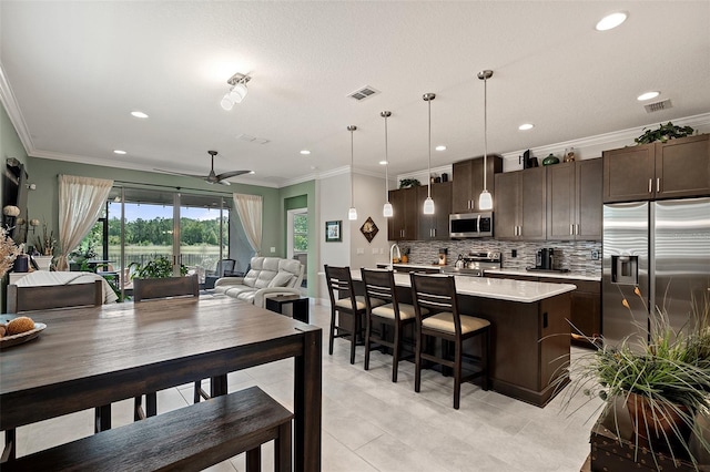 3428 Sagebrush St, Saint Cloud, FL 34773 - kitchen featuring appliances with stainless steel finishes, dark brown cabinetry, ceiling fan, light countertops, and recessed lighting