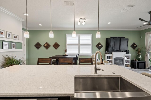 3428 Sagebrush St, Saint Cloud, FL 34773 - kitchen with a sink, a ceiling fan, open floor plan, decorative light fixtures, and ornamental molding