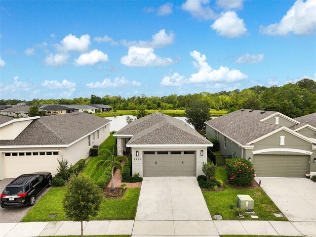 3428 Sagebrush St, Saint Cloud, FL 34773 - view of front of home featuring concrete driveway, a front yard, stucco siding, and an attached garage