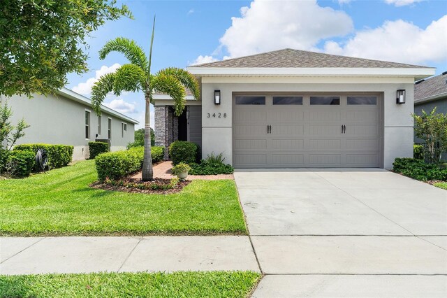 3428 Sagebrush St, Saint Cloud, FL 34773 - ranch-style home featuring stucco siding, driveway, a garage, and a front yard