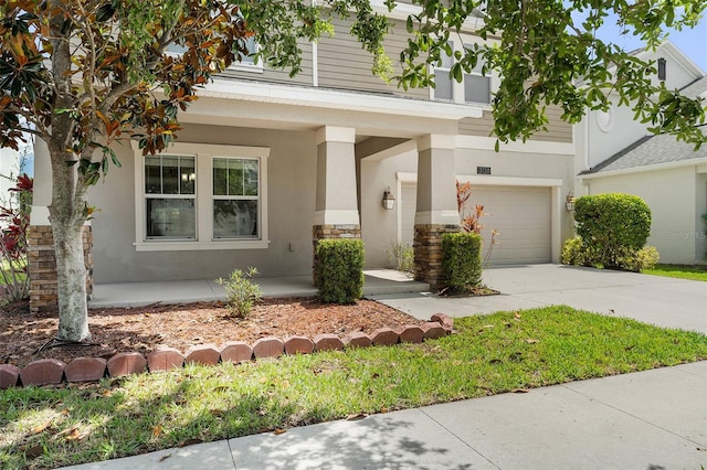 3138 Dark Sky Dr, Saint Cloud, FL 34773 - view of front of home with stucco siding, concrete driveway, an attached garage, and a porch