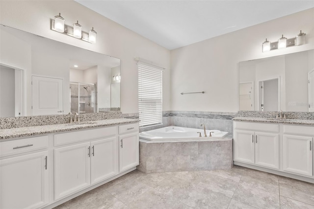 3138 Dark Sky Dr, Saint Cloud, FL 34773 - full bath featuring a stall shower, a garden tub, and two vanities