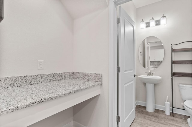 3138 Dark Sky Dr, Saint Cloud, FL 34773 - bathroom featuring toilet, wood finished floors, baseboards, and a sink