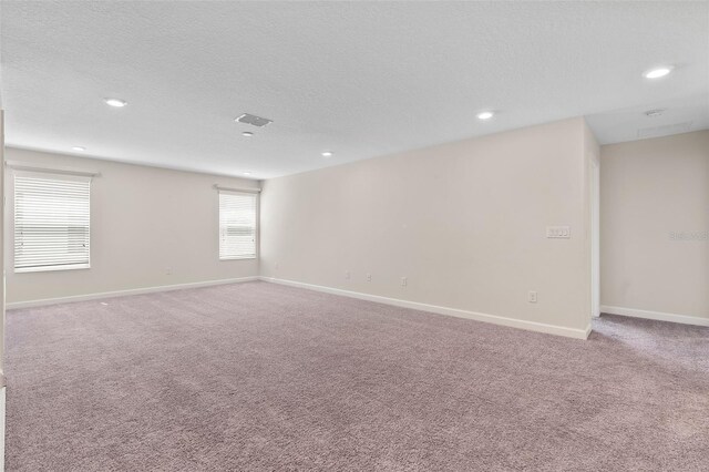 3138 Dark Sky Dr, Saint Cloud, FL 34773 - carpeted spare room featuring baseboards, recessed lighting, and a textured ceiling