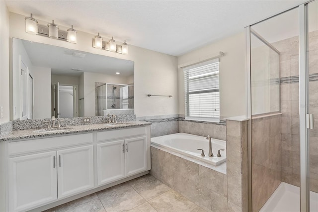 3138 Dark Sky Dr, Saint Cloud, FL 34773 - bathroom featuring a stall shower, a bath, double vanity, and tile patterned floors