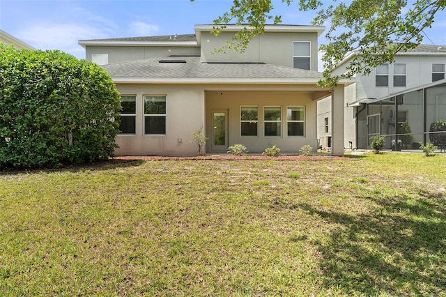 3138 Dark Sky Dr, Saint Cloud, FL 34773 - back of house featuring stucco siding, a lawn, and roof with shingles