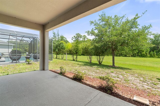 3138 Dark Sky Dr, Saint Cloud, FL 34773 - view of patio with a swimming pool, a lanai, and view of wooded area