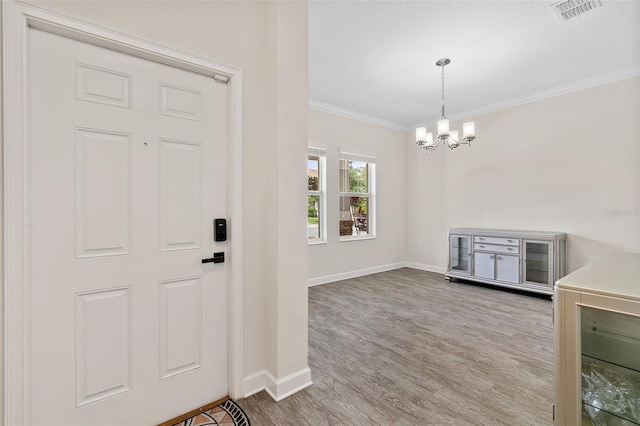 3138 Dark Sky Dr, Saint Cloud, FL 34773 - entryway featuring a chandelier, baseboards, crown molding, and wood finished floors