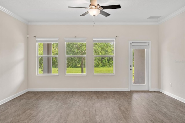 3138 Dark Sky Dr, Saint Cloud, FL 34773 - spare room featuring plenty of natural light, wood finished floors, ceiling fan, crown molding, and baseboards