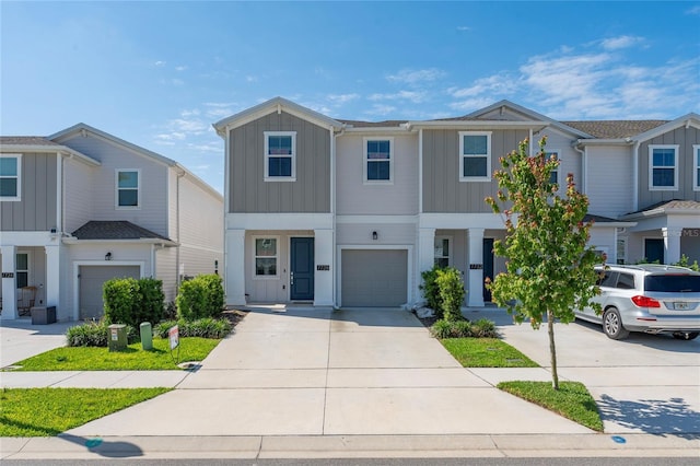 7728 Stone Creek Trl, Kissimmee, FL 34747 - view of front of home with board and batten siding, concrete driveway, and an attached garage