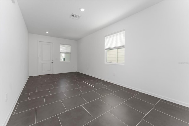 7728 Stone Creek Trl, Kissimmee, FL 34747 - unfurnished room with recessed lighting, baseboards, and dark tile patterned flooring