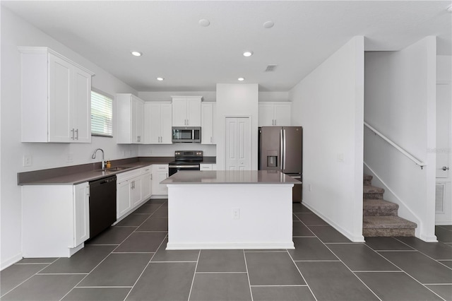 7728 Stone Creek Trl, Kissimmee, FL 34747 - kitchen featuring stainless steel appliances, a sink, white cabinetry, and recessed lighting