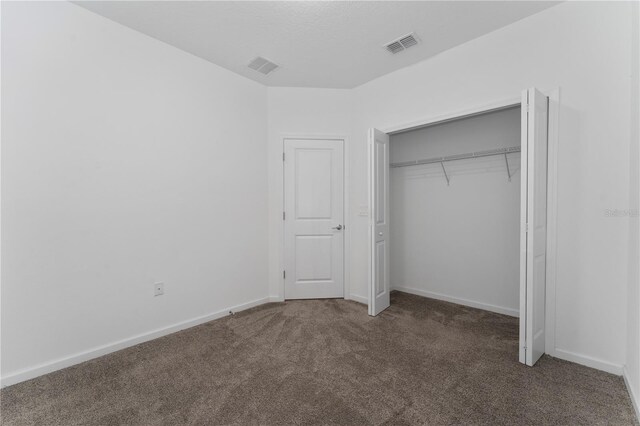 7728 Stone Creek Trl, Kissimmee, FL 34747 - unfurnished bedroom featuring carpet, baseboards, and a closet