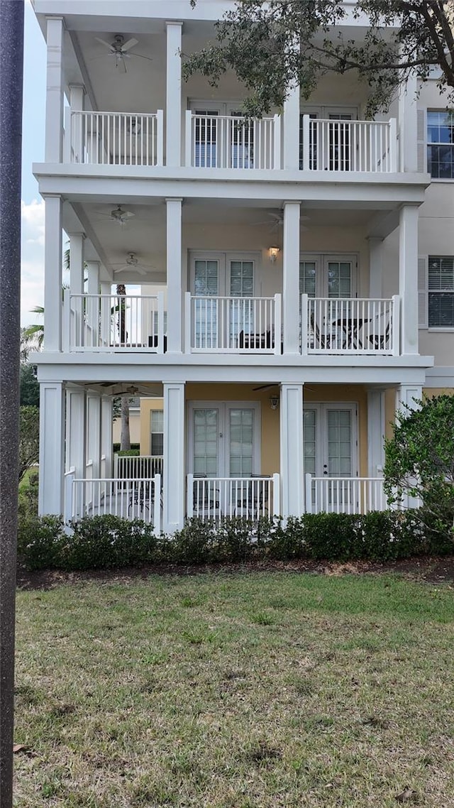 7509 Mourning Dove Cir Unit 303, Reunion, FL 34747 - back of property with a balcony, stucco siding, a yard, and ceiling fan