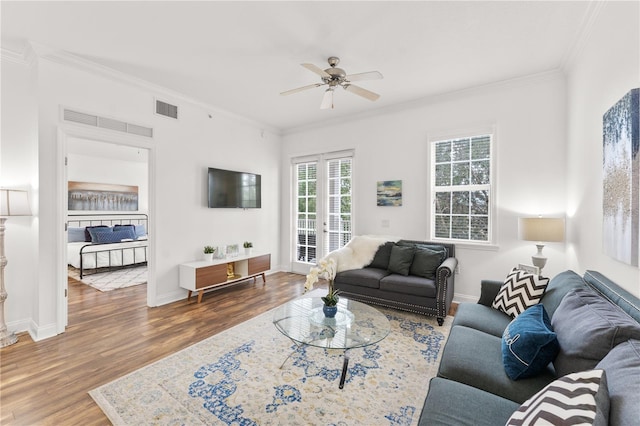 7509 Mourning Dove Cir Unit 303, Reunion, FL 34747 - living room featuring crown molding, ceiling fan, wood finished floors, and baseboards