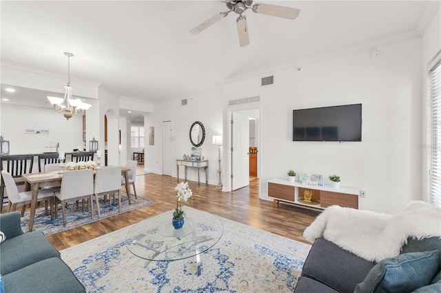 7509 Mourning Dove Cir Unit 303, Reunion, FL 34747 - living room with ornamental molding, a ceiling fan, wood finished floors, a chandelier, and arched walkways