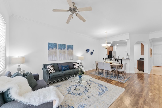 7509 Mourning Dove Cir Unit 303, Reunion, FL 34747 - living room featuring ornamental molding, a ceiling fan, light wood-style flooring, arched walkways, and baseboards