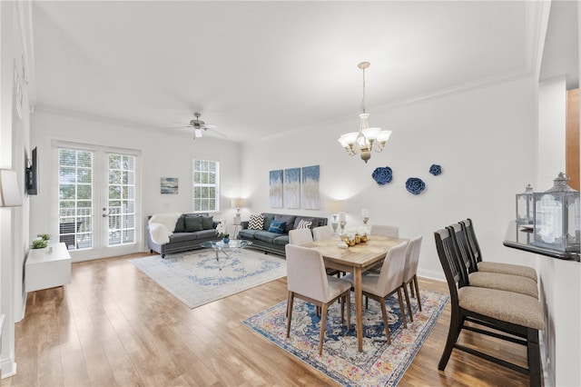 7509 Mourning Dove Cir Unit 303, Reunion, FL 34747 - dining room with a chandelier, light wood-style floors, a ceiling fan, french doors, and ornamental molding