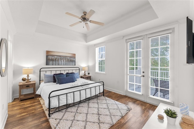 7509 Mourning Dove Cir Unit 303, Reunion, FL 34747 - bedroom with a tray ceiling, access to outside, wood-type flooring, french doors, and ornamental molding