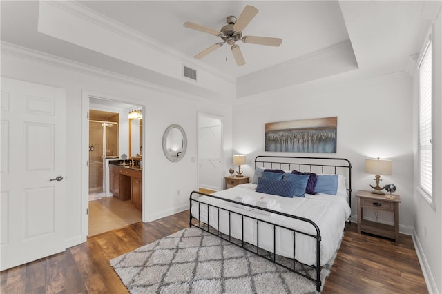 7509 Mourning Dove Cir Unit 303, Reunion, FL 34747 - bedroom featuring wood finished floors, baseboards, ornamental molding, ceiling fan, and ensuite bath