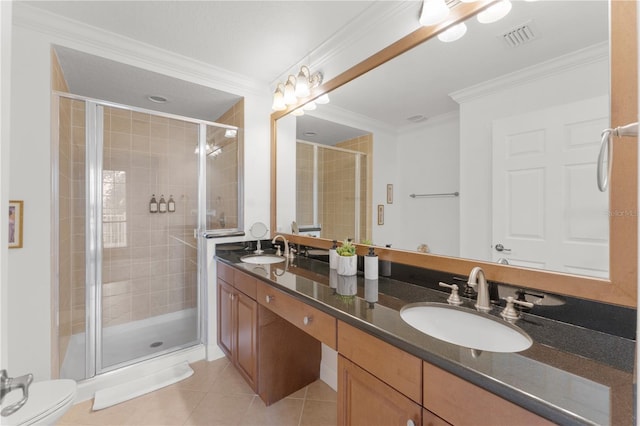 7509 Mourning Dove Cir Unit 303, Reunion, FL 34747 - bathroom featuring a stall shower, tile patterned floors, crown molding, double vanity, and toilet