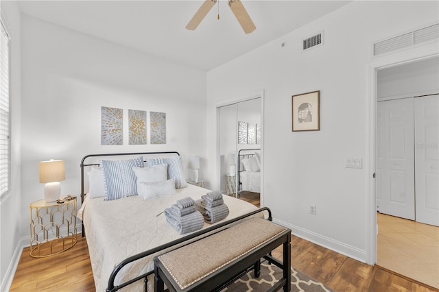 7509 Mourning Dove Cir Unit 303, Reunion, FL 34747 - bedroom with baseboards, wood finished floors, a ceiling fan, and a closet