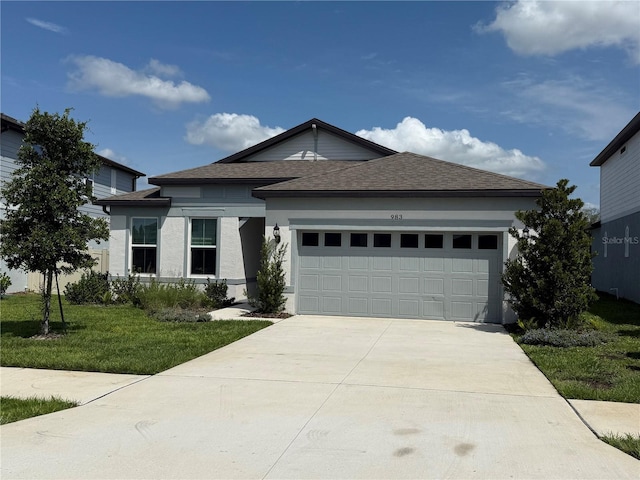 983 Silverlake Blvd, Lake Alfred, FL 33850 - view of front facade featuring a garage, a shingled roof, concrete driveway, a front lawn, and stucco siding