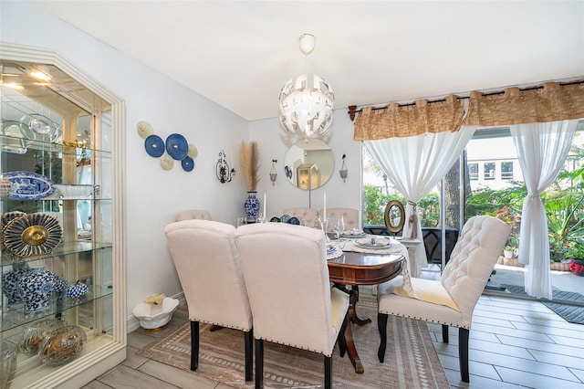 4403 S Semoran Blvd Unit 2, Orlando, FL 32822 - dining area featuring a chandelier and wood finished floors