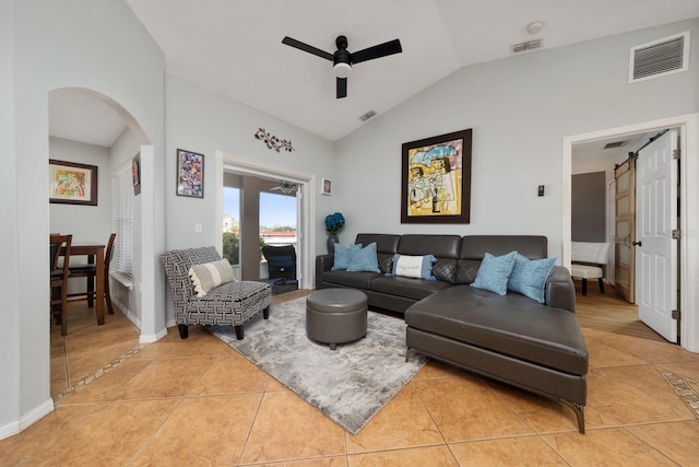 402 Ohio Way, Kissimmee, FL 34759 - living room featuring a ceiling fan, lofted ceiling, light tile patterned floors, arched walkways, and a barn door