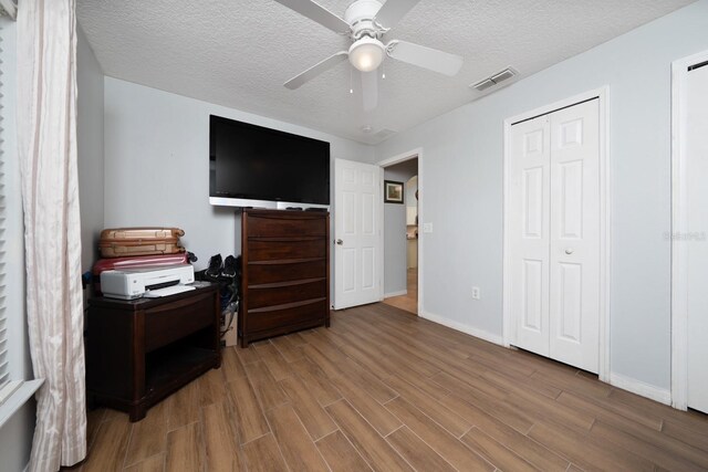 402 Ohio Way, Kissimmee, FL 34759 - bedroom with wood finished floors, a textured ceiling, baseboards, and ceiling fan