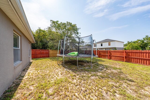 402 Ohio Way, Kissimmee, FL 34759 - view of yard featuring a trampoline