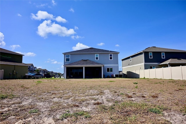 673 Sarner Pass Way, Winter Haven, FL 33881 - back of house with fence, a sunroom, a garage, roof with shingles, and central AC unit