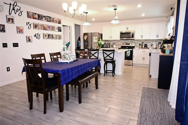 673 Sarner Pass Way, Winter Haven, FL 33881 - dining space with a chandelier, wood tiled floors, baseboards, and recessed lighting