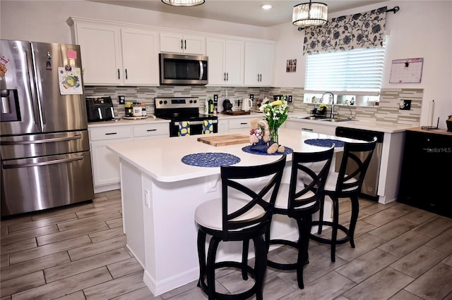 673 Sarner Pass Way, Winter Haven, FL 33881 - kitchen with stainless steel appliances, a sink, wood tiled floors, and light countertops