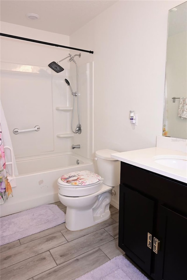 673 Sarner Pass Way, Winter Haven, FL 33881 - bathroom featuring toilet, shower / bathtub combination, wood finished floors, and vanity