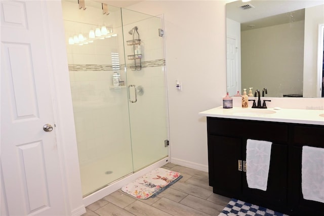 673 Sarner Pass Way, Winter Haven, FL 33881 - bathroom with a shower stall, vanity, wood tiled floors, and baseboards